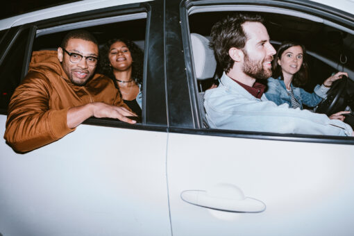 A diverse group of multiethnic friends take a rideshare carpool for transportation to their next destination in downtown L.A. California.