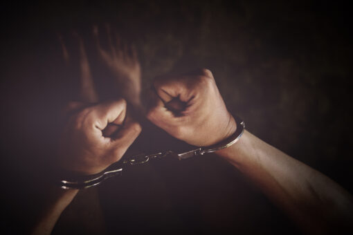 criminal tying hands with handcuffs.