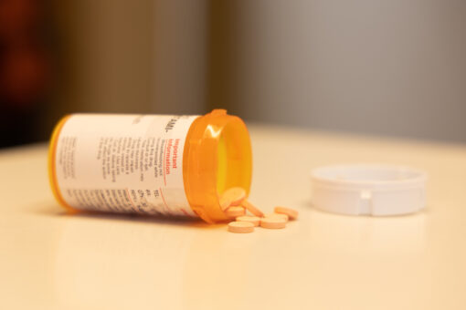 This is a photo of some ADHD medication on a counter. The pills are coming out of the bottle.
